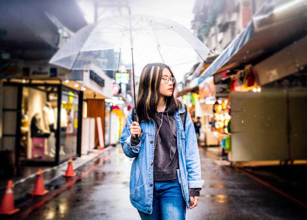 asian woman walking with umbrella