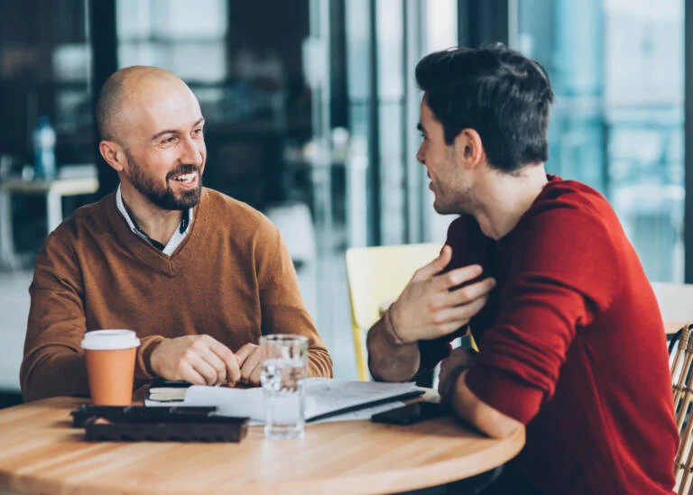 two men talking in a cafe