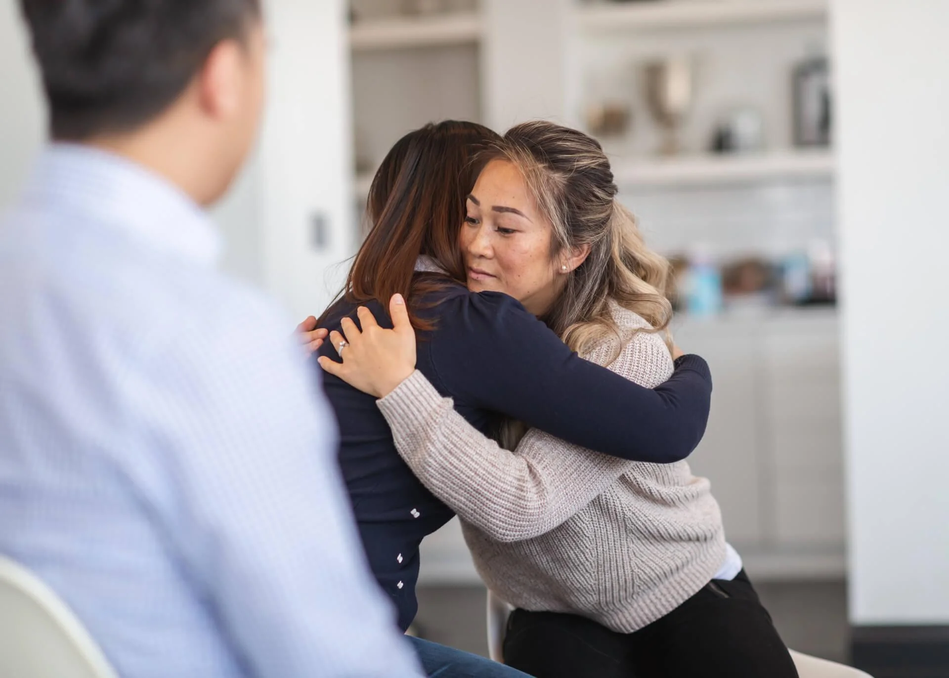 older woman hugging younger woman