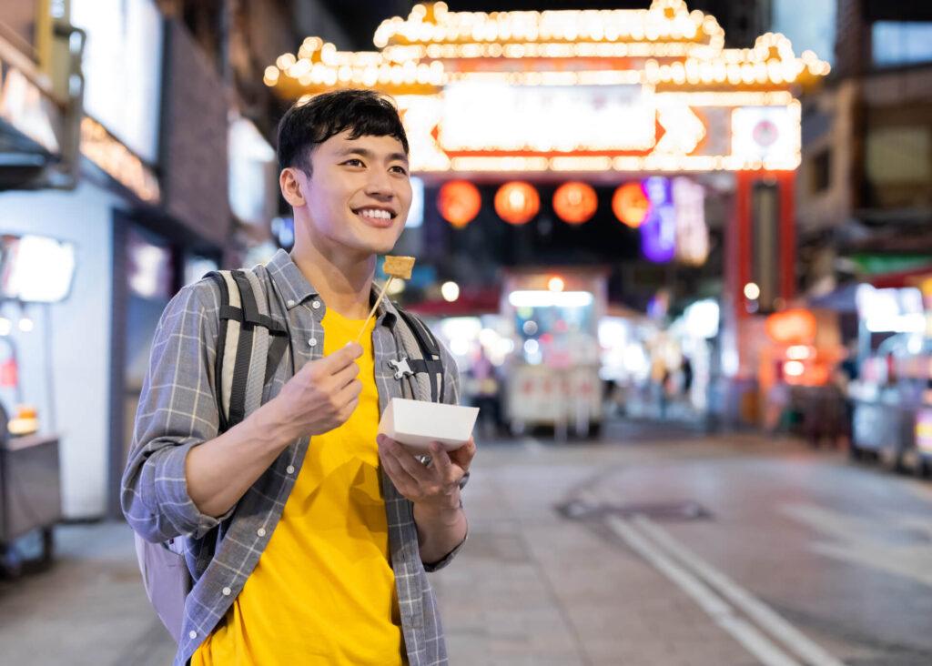 chinese guy eating stinky tofu