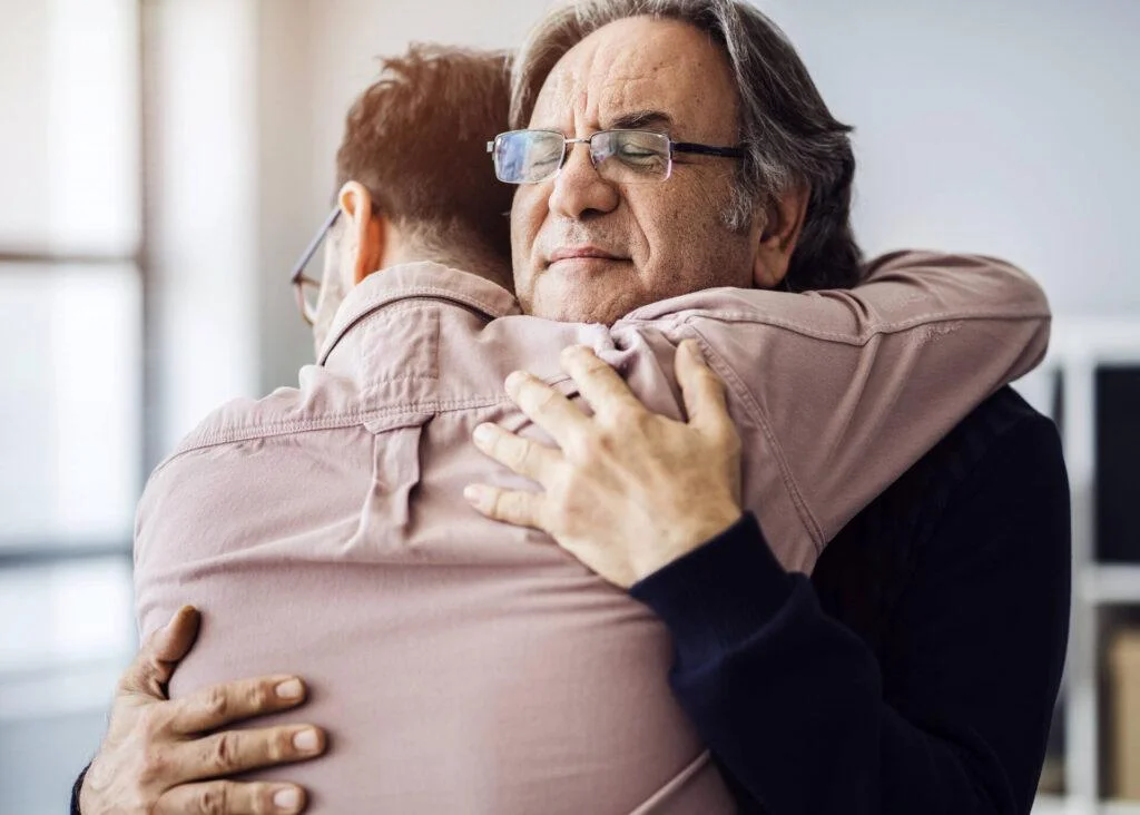 father and son embrace