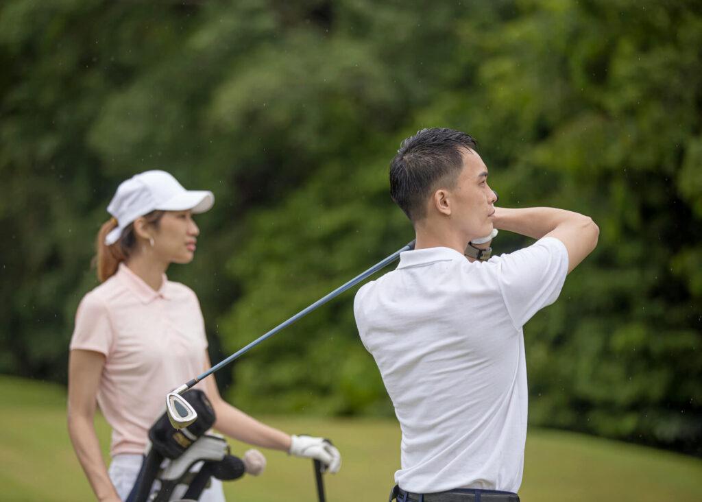 asian couple playing golf