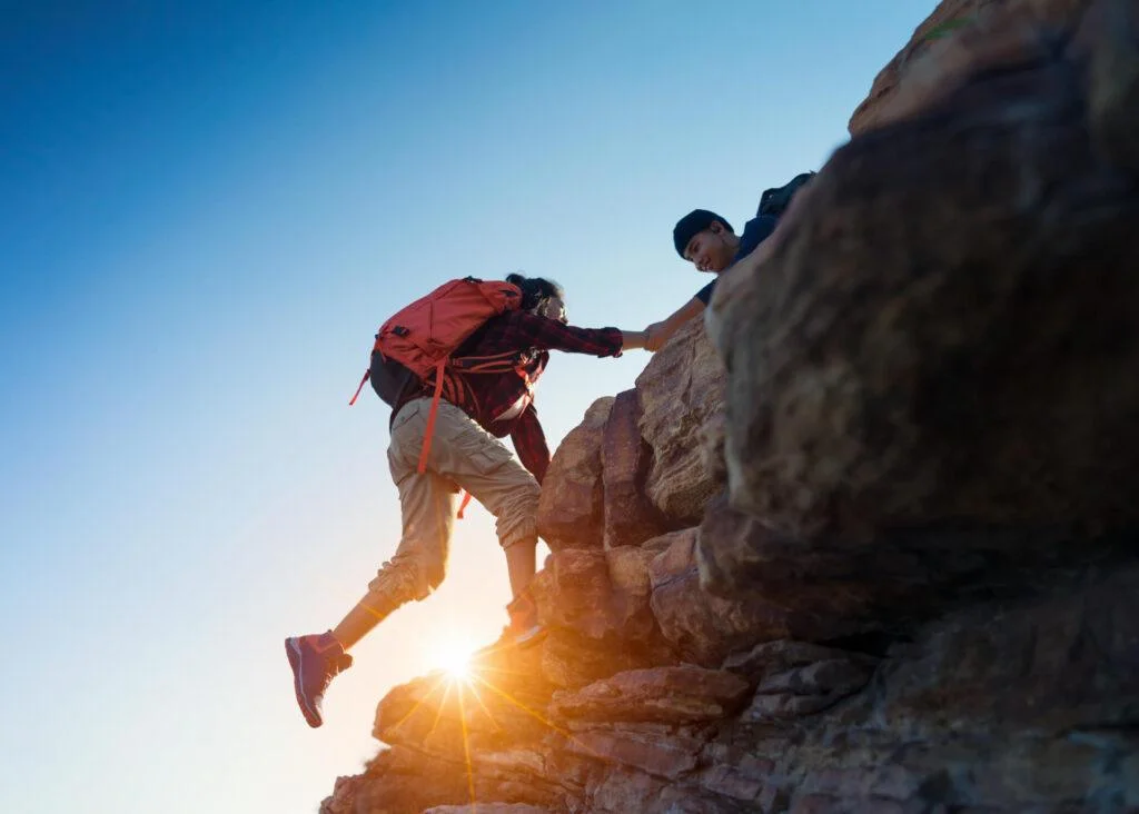 man climbing mountains