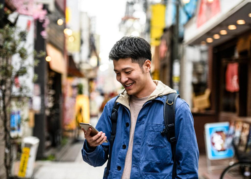 young asian man checking phone