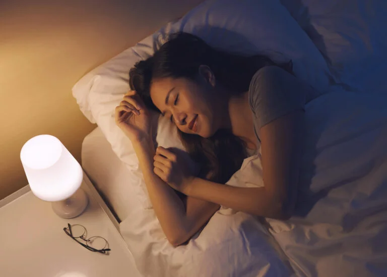 asian woman falling asleep in bed