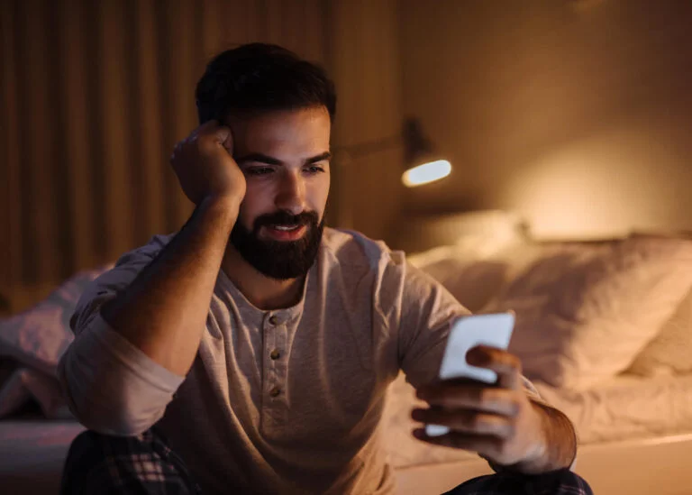 man texting good night on his phone