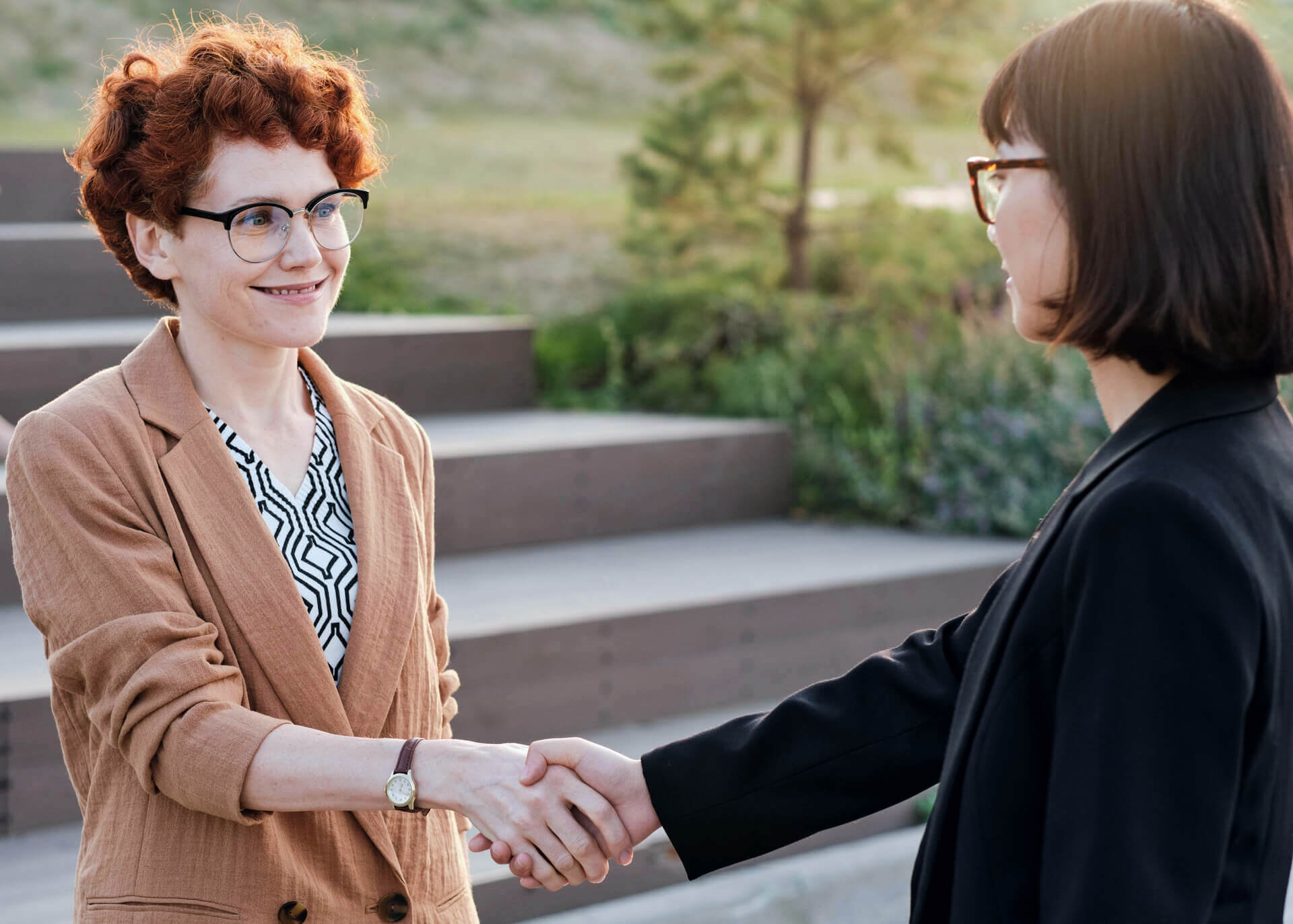 two businesswomen greeting each other
