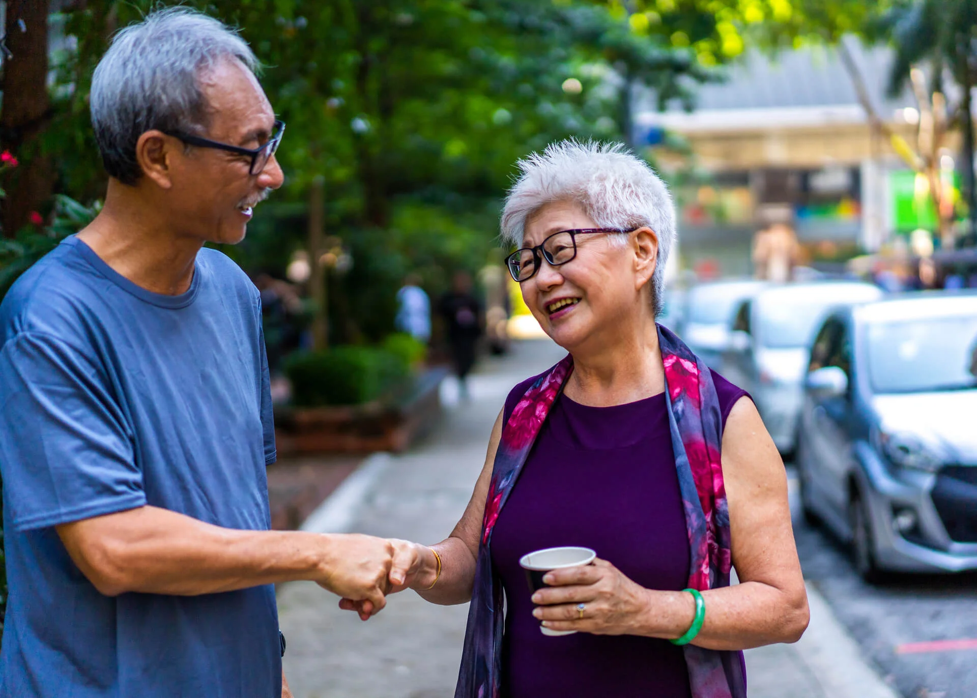 two elderly people meeting on the street