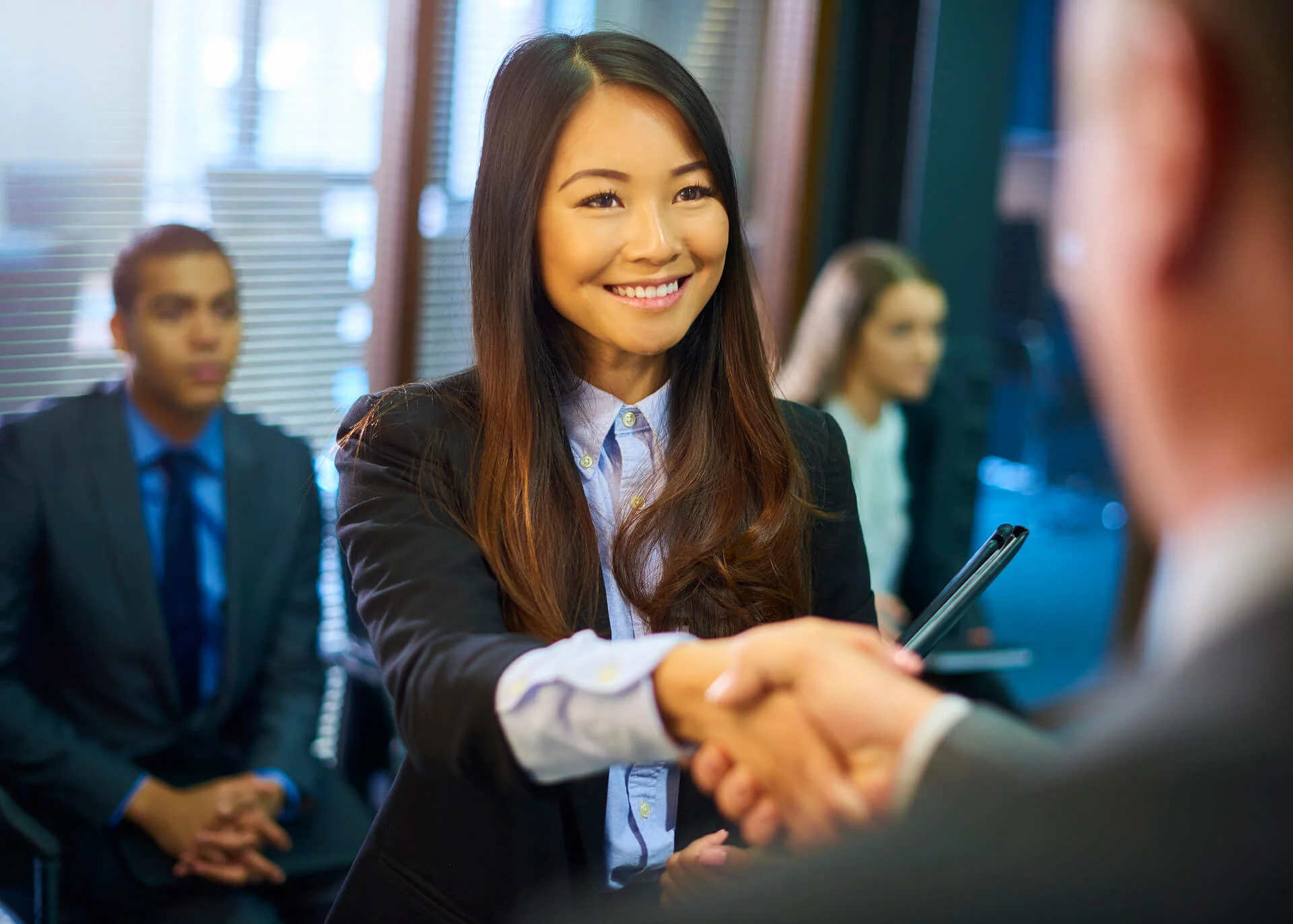 woman greeting business partners