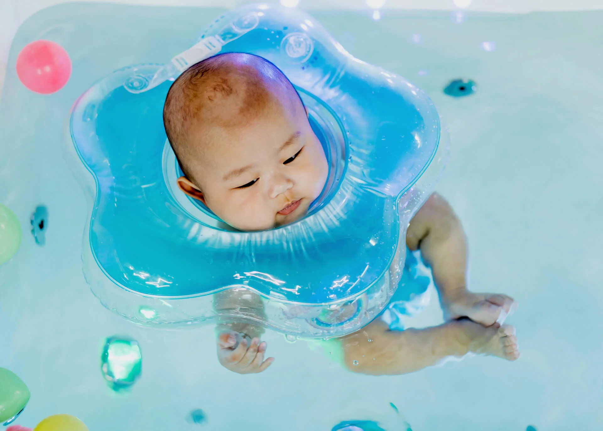 baby swimming in a tub
