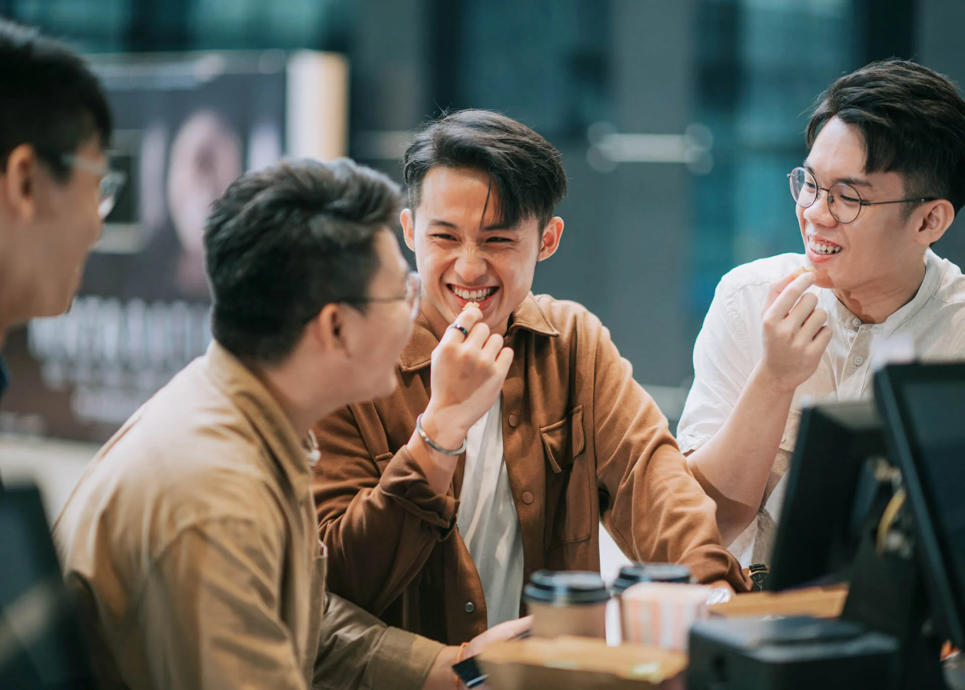 chinese guys chatting in a cafe