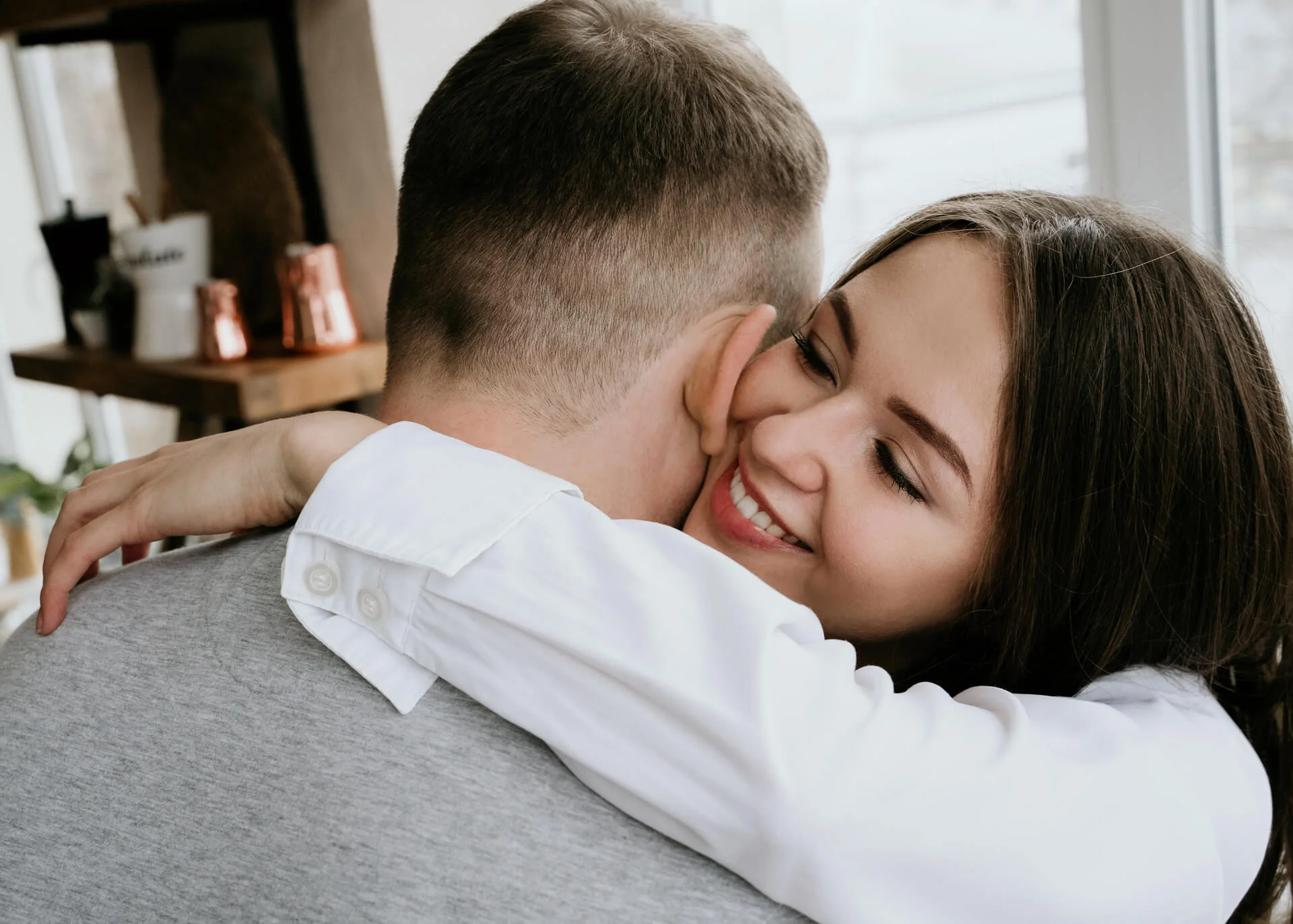 smiling chinese woman hugging her boyfriend