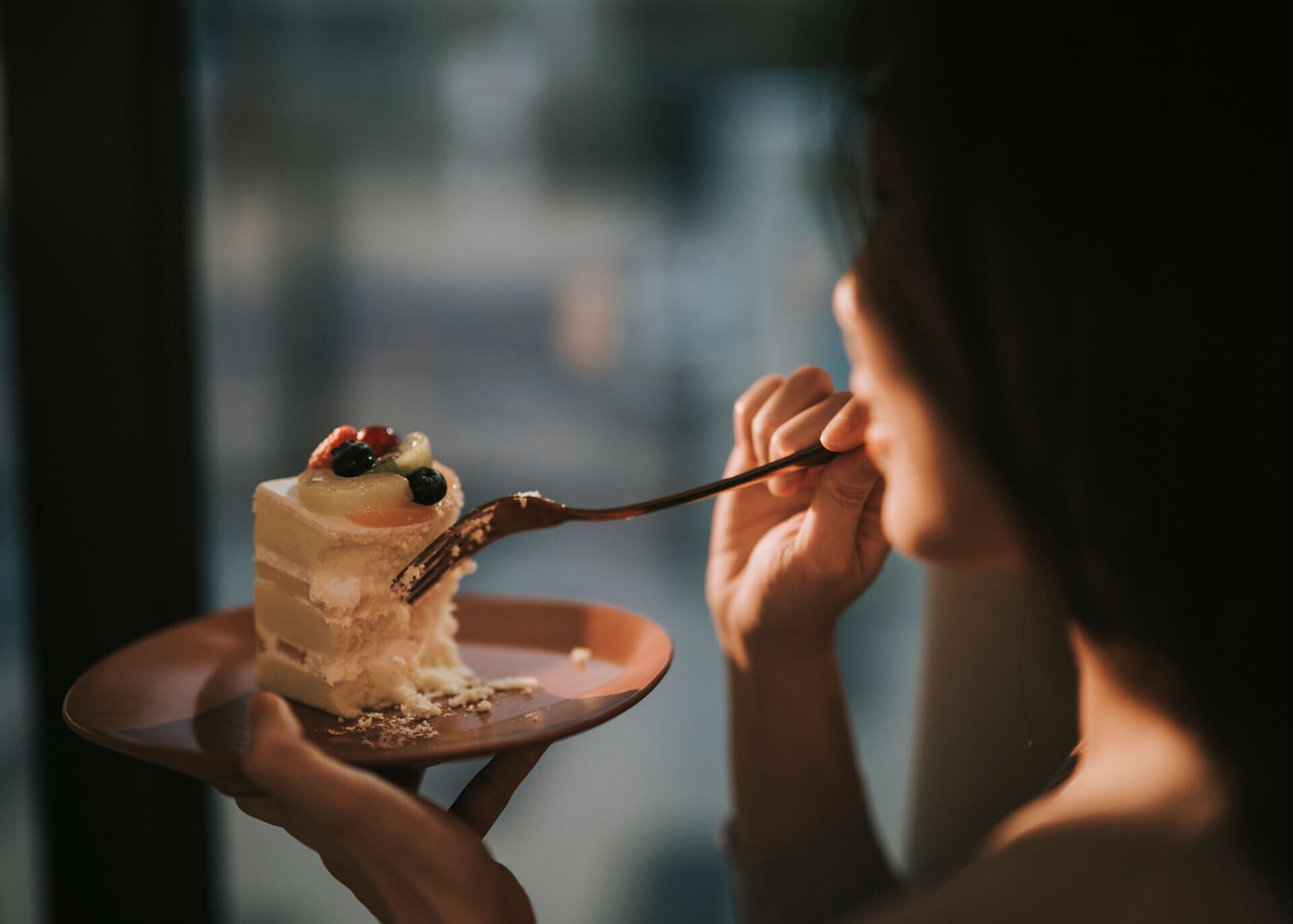 asian woman eating cake