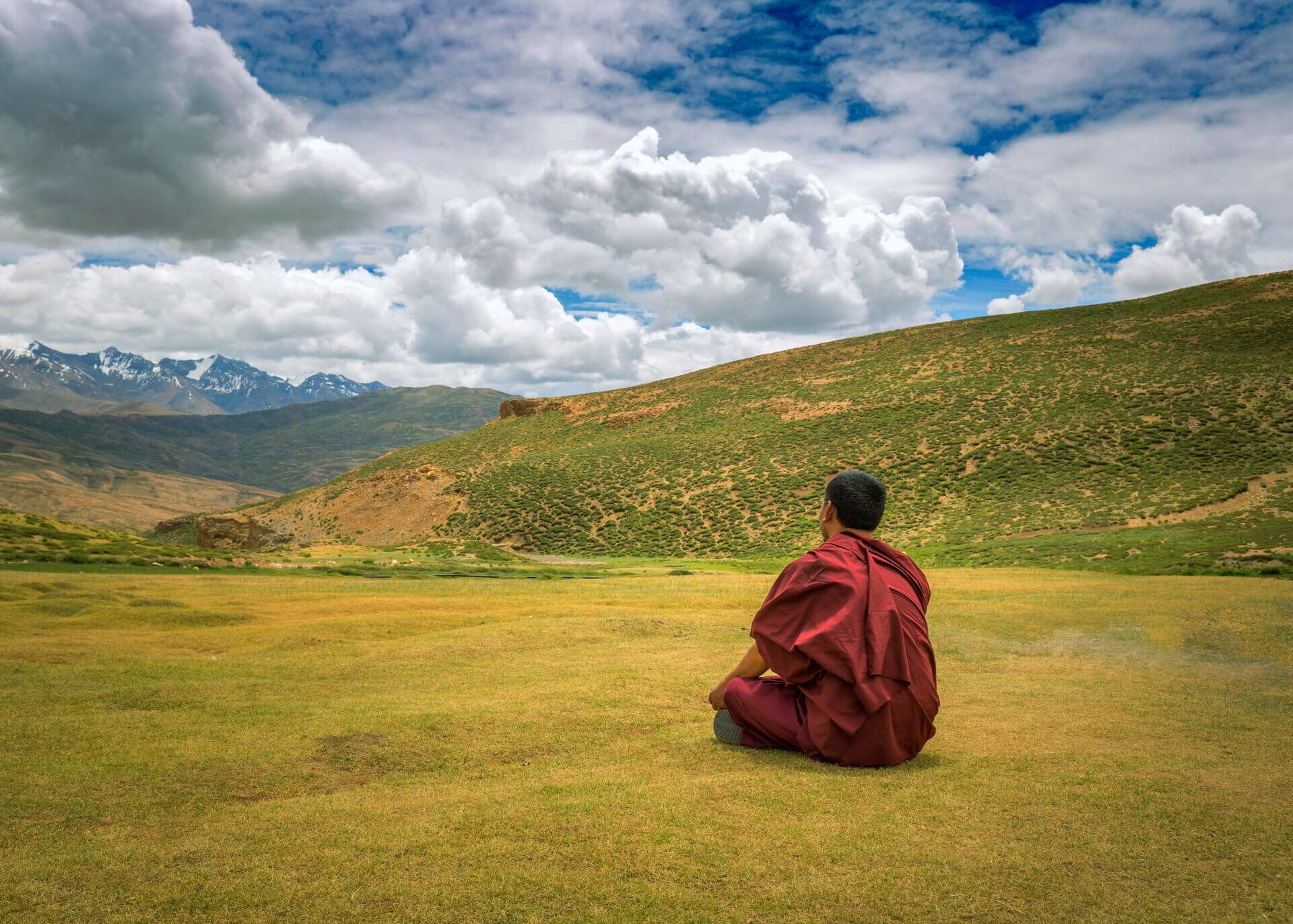 buddhist monk meditating in the valley
