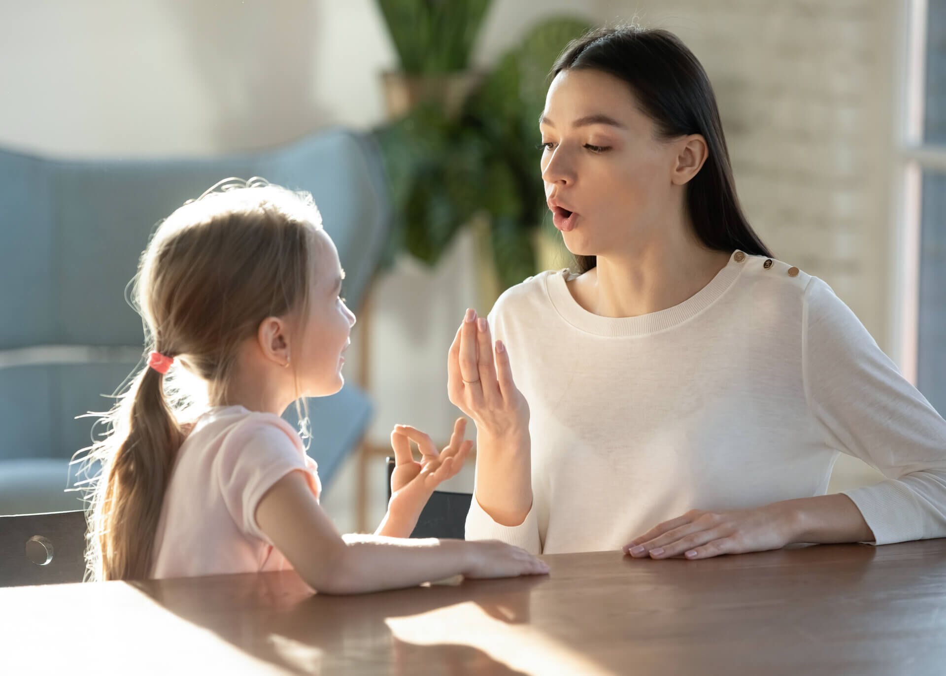 mother teaching daughter pronunciation