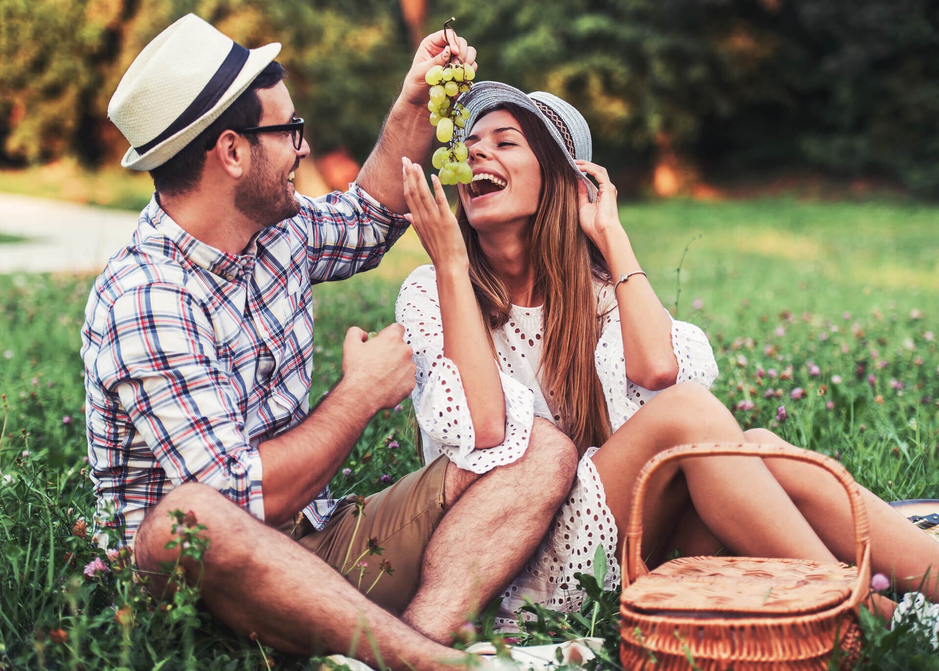 young couple eating grapes