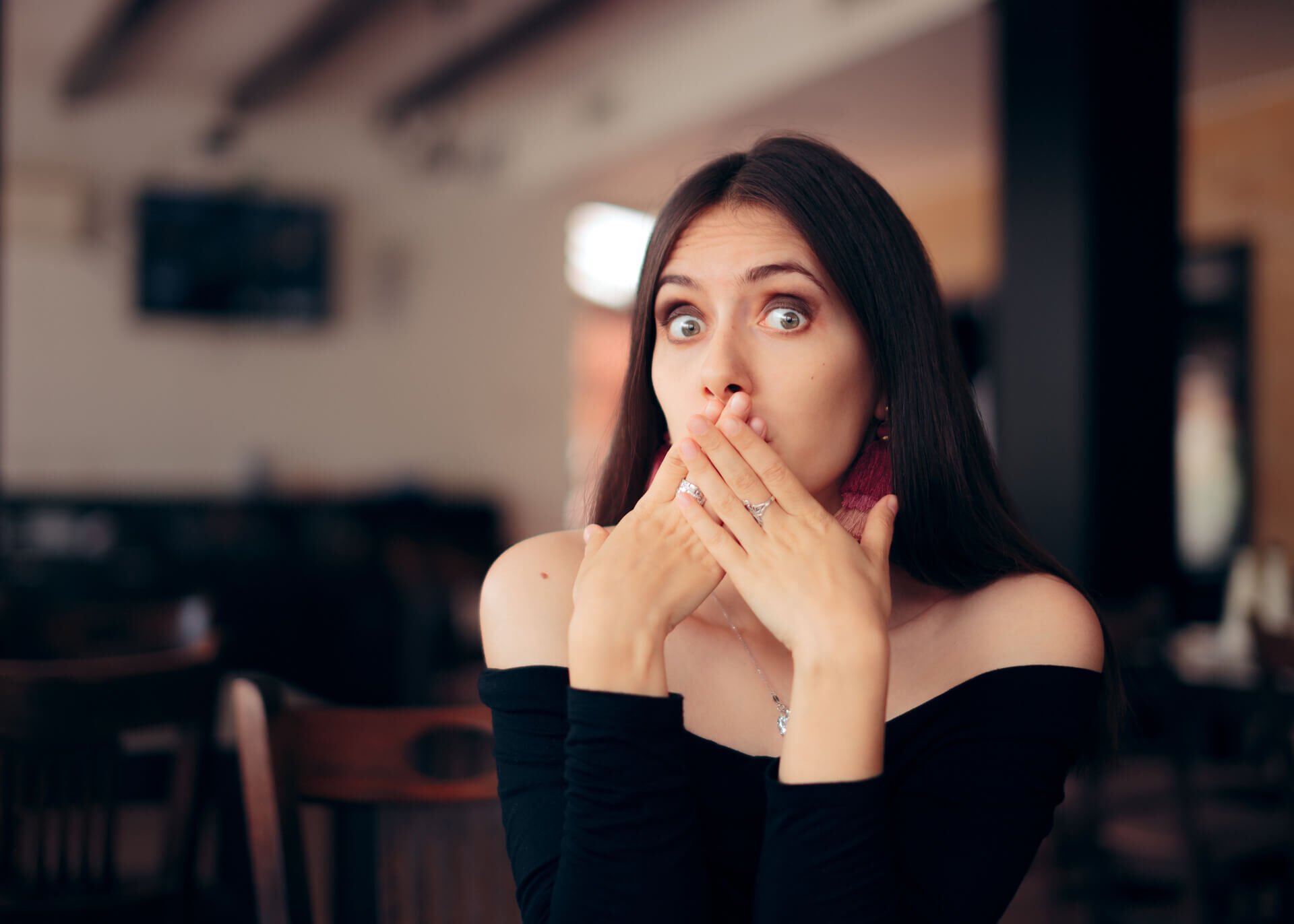 woman covering her mouth