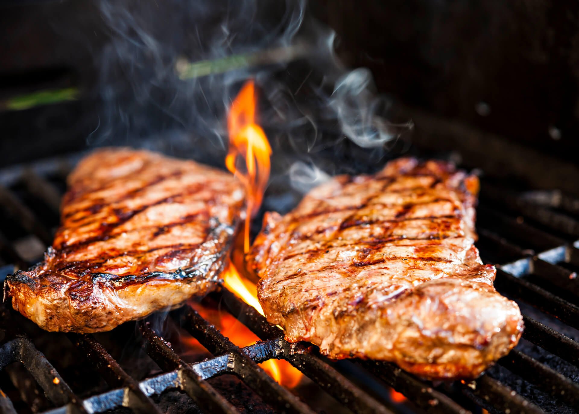 two steaks on a grill