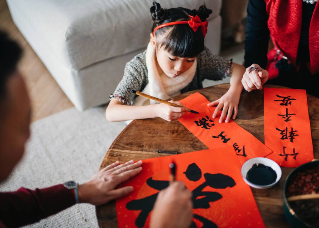 little girl writing chinese words