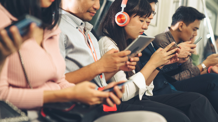 young-people-using-mobile-phone-public