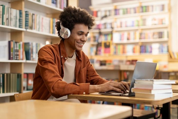 dedicated-smiling-black-male-student-engaged-in-online-learning