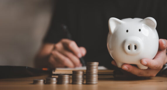 man-hand-holding-piggy-bank