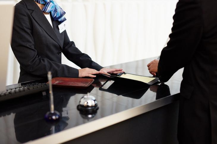 welcome-hotel-male-female-receptionists-standing