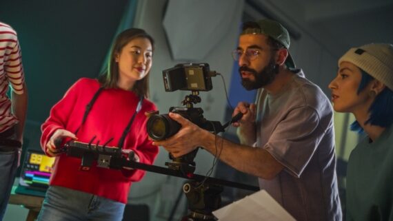 young-asian-female-and-middle-eastern-male-cinematographer-on-film-seat